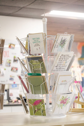 Spinning rack of greeting cards at The Willow Collective